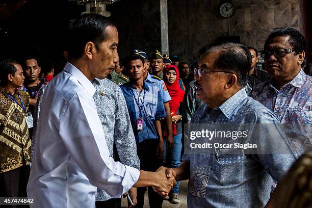 Indonesian President-elect Joko Widodo talk with Vice President-elect Jusuf Kalla after inauguration rehearsal on October 19, 2014 in Jakarta,...