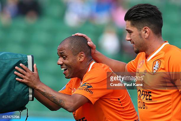 Henrique De Silva of the Roar celebrates after scoring a goal with Dimitri Petratos during the round two A-League match between the Perth Glory and...