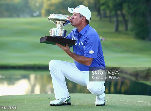 Scott Hend of Australia celebrates with the trophy after winning the final round of the 2014 Hong Kong open at The Hong Kong Golf Club on October 19,...