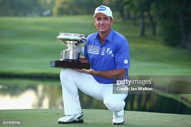 Scott Hend of Australia celebrates with the trophy after winning the final round of the 2014 Hong Kong open at The Hong Kong Golf Club on October 19,...