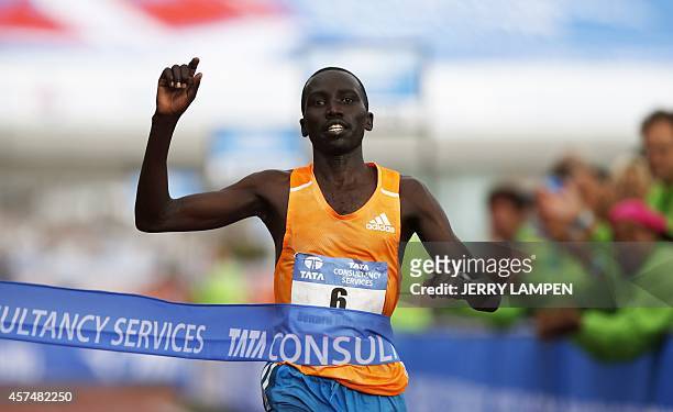 Kenya's Bernard Kipyego gestures as he crosses the finish line to win the Amsterdam Marathon on October 19, 2014. AFP PHOTO/ANP/JERRY LAMPEN ==...