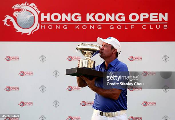 Scott Hend of Australia celebrates with the trophy after winning the final round of the 2014 Hong Kong open at The Hong Kong Golf Club on October 19,...