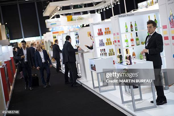 Man waits at the Spanish Bodegas Mayador stand at the SIAL , on October 19, 2014 in Villepinte east of Paris. AFP PHOTO MARTIN BUREAU