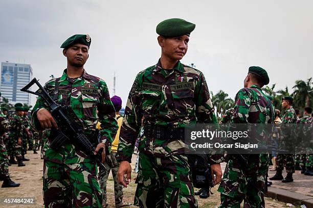 Security guards walk around the National Monument as they prepare for the inaguration of Indonesia President Joko Widodo on October 19, 2014 in...