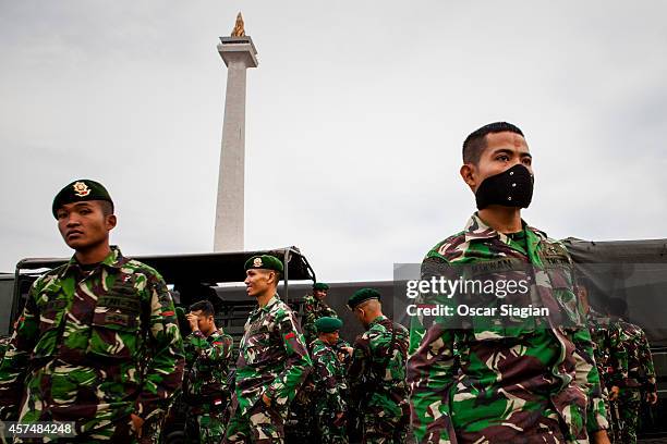 Security guards walk around the National Monument as they prepare for the inaguration of Indonesia President Joko Widodo on October 19, 2014 in...