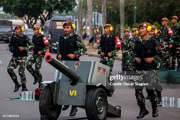 The Indonesian army rehearse around the National Monument as they prepare for the inaguration of Indonesia President Joko Widodo on October 19, 2014...