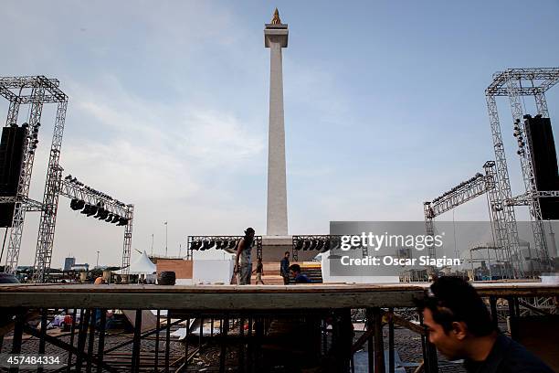 Workers build the stage as they prepre for the inaguration Indonesian President Joko Widodo at the National Monument on October 19, 2014 in Jakarta,...