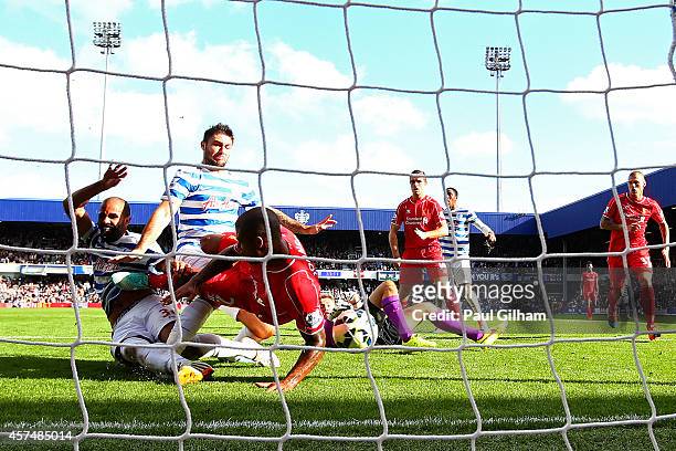 Glen Johnson of Liverpool blocks an attempt from Sandro and Charlie Austin of QPR during the Barclays Premier League match between Queens Park...