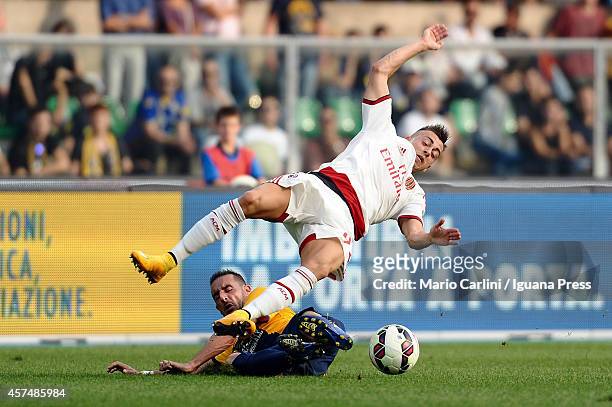 Stephan El Shaarawy of AC Milan competes the ball with Alessandro Agostini of Hellas Verona FC during the Serie A match between Hellas Verona FC and...