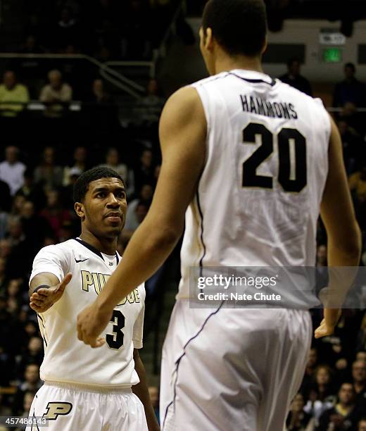 Ronnie Johnson of the Purdue Boilermakers reaches out to high-five teammate A.J. Hammons during a game against the Eastern Michigan Eagles on...