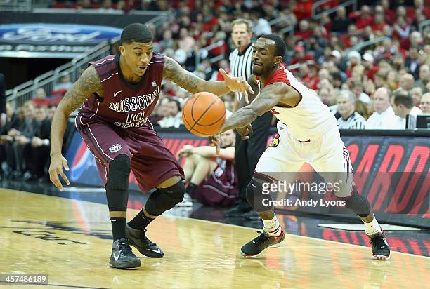 Russ Smith of the Louisville Cardinals knocks the ball away from Ron Mvouika of the Missouri State Bears during the game at KFC YUM! Center on...