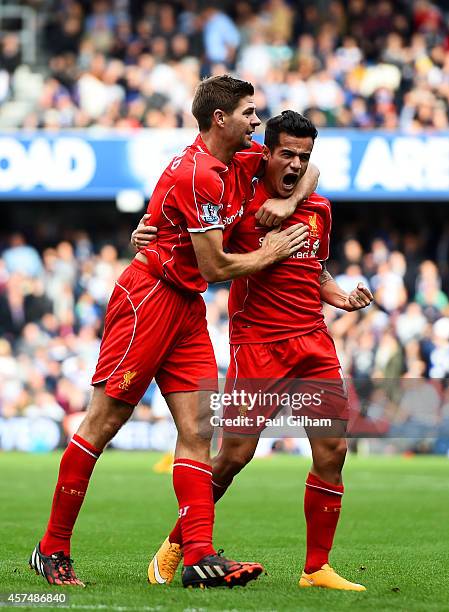 Philippe Coutinho of Liverpool celebrates with team-mate Steven Gerrard after scoring his team's second goal during the Barclays Premier League match...