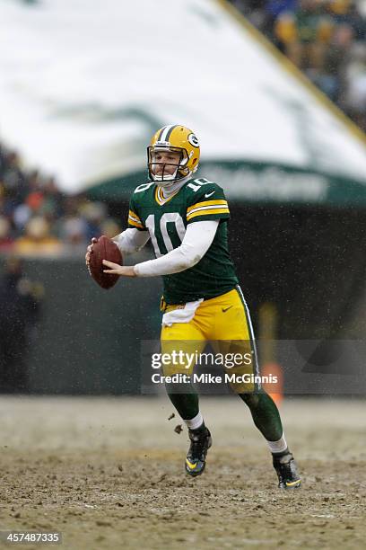 Matt Flynn of the Green Bay Packers scrambles out of the pocket and passes the football during the game against the Atlanta Falcons at Lambeau Field...