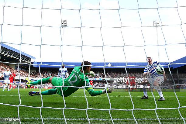 Richard Dunne of QPR scores an own goal past Alex McCarthy during the Barclays Premier League match between Queens Park Rangers and Liverpool at...