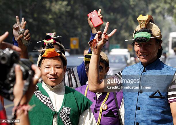 Supporters from North-eastern state of Nagaland celebrate following the results of Haryana and Maharashtra state assembly elections at BJP party...