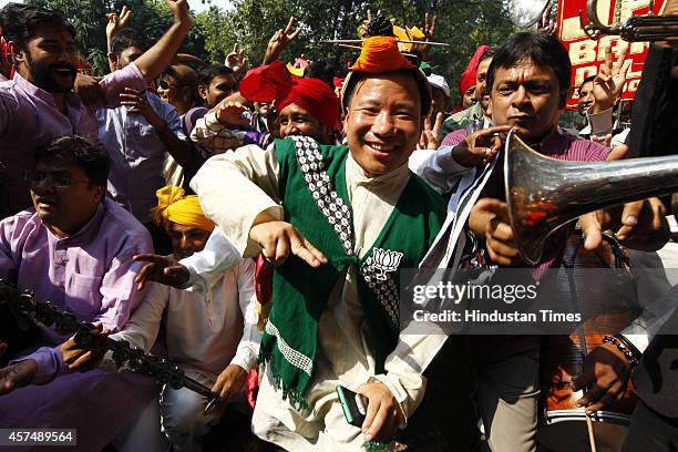 Supporter from North-eastern state of Nagaland celebrates following the results of Haryana and Maharashtra state assembly elections at BJP party...