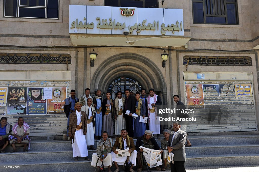 Houthis stand guard outside governor's building in Sana'a