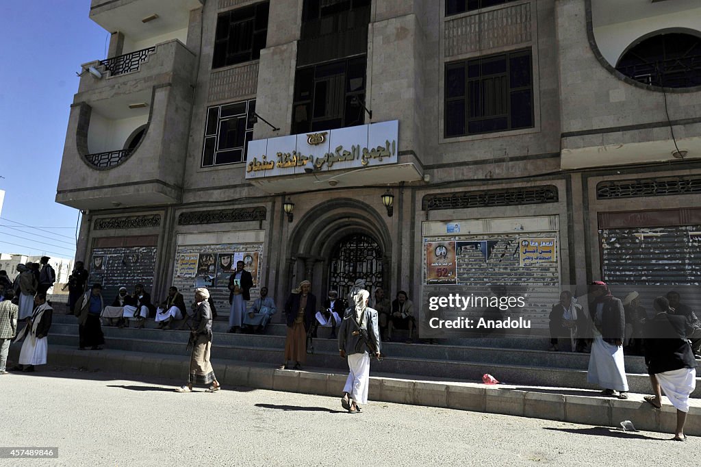 Houthis stand guard outside governor's building in Sana'a