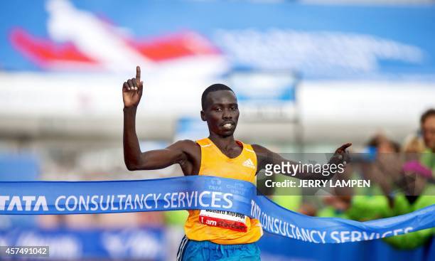 Bernard Kipyego of Kenya crosses the finish line to win the Amsterdam Marathon on October 19, 2014. AFP PHOTO / ANP / JERRY LAMPEN netherlands out