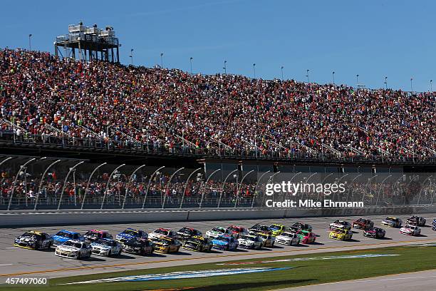 Brian Vickers, driver of the Aaron's Dream Machine Toyota, and Jimmie Johnson, driver of the Lowe's Chevrolet, lead the field at the start the NASCAR...