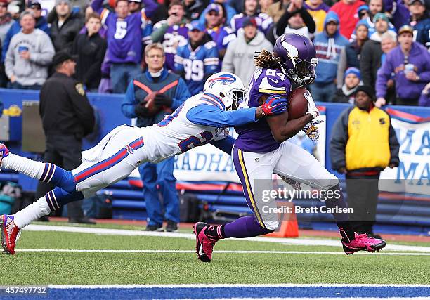 Cordarrelle Patterson of the Minnesota Vikings scores a touchdown as Corey Graham of the Buffalo Bills defends during the first half at Ralph Wilson...