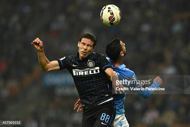Anderson Hernanes of FC Internazionale Milano clashes with Miguel Angel Britos of SSC Napoli during the Serie A match between FC Internazionale...