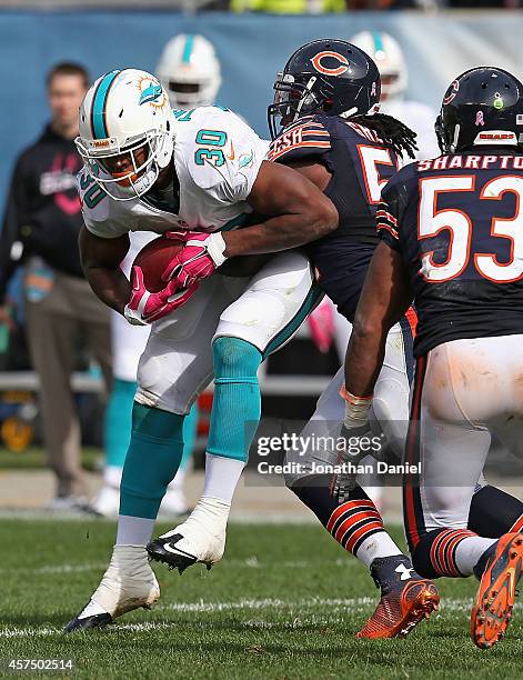 Daniel Thomas of the Miami Dolphins is tackled by Khaseem Greene of the Chicago Bears during the third quarter at Soldier Field on October 19, 2014...