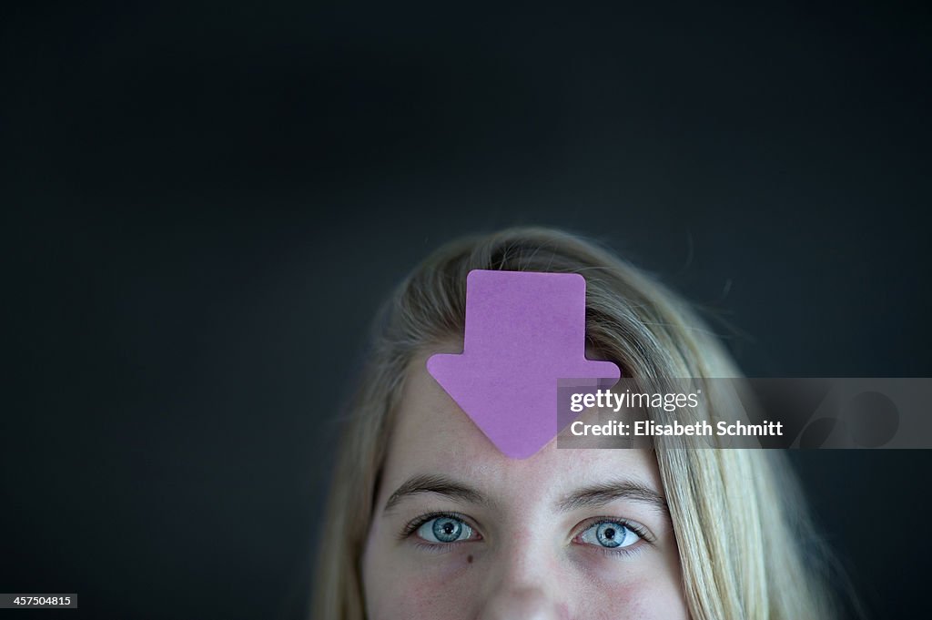Partial portrait of girl with sticker on forehead