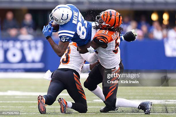 Reggie Wayne of the Indianapolis Colts is tackled by Terence Newman of the Cincinnati Bengals and Jayson DiManche of the Cincinnati Bengals during...