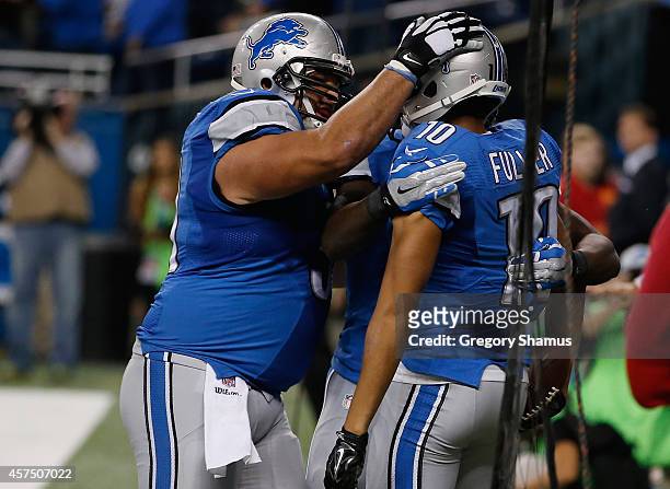 Corey Fuller and Dominic Raiola of the Detroit Lions celebrate a fourth-quarter touchdown pass against the New Orleans Saints at Ford Field on...