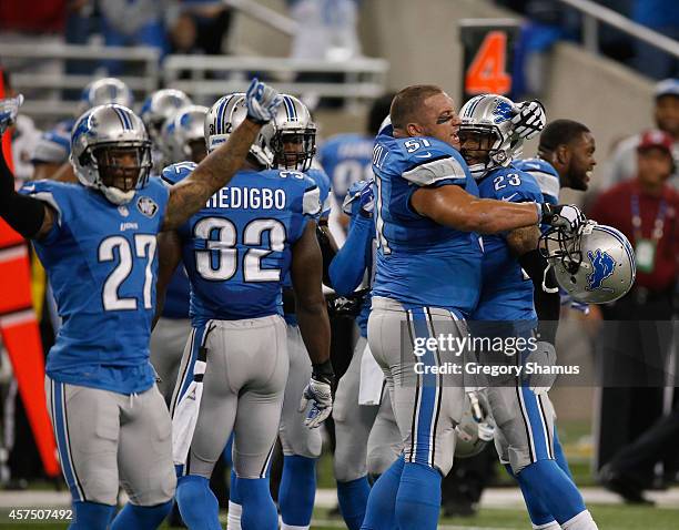 Darius Slay and Dominic Raiola of the Detroit Lions celebrate with teammates after a 24-23 win over the New Orleans Saints at Ford Field on October...