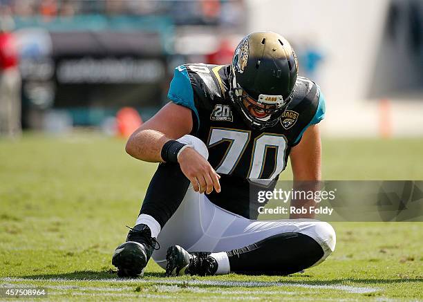 Luke Bowanko of the Jacksonville Jaguars sits injured on the field during the second half of the game against the Cleveland Browns at EverBank Field...