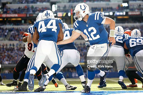 Andrew Luck of the Indianapolis Colts hands the ball off to Ahmad Bradshaw of the Indianapolis Colts while backed up to the one yard line during the...