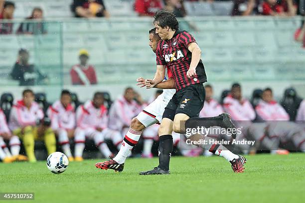 Cleo of Atletico-PR competes for the ball with Victor Caceres of Flamengo during the match between Atletico-PR and Flamengo for the Brazilian Series...