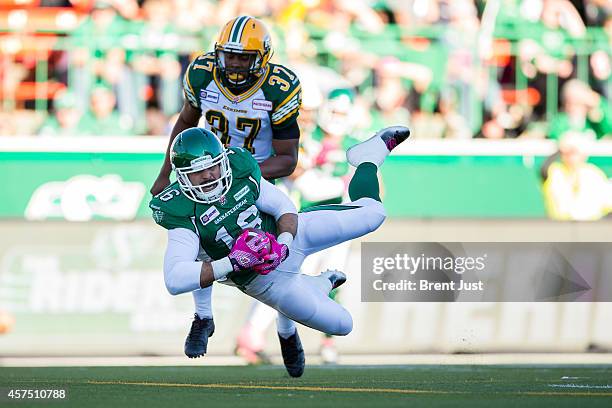 Brett Swain of the Saskatchewan Roughriders makes a diving catch for a touchdown in front of Otha Foster of the Edmonton Eskimos late in the first...