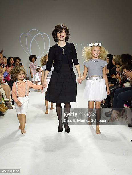 Designer Rany Mendlovic walks the runway with models during the Charm preview at petitePARADE / Kids Fashion Week at Bathhouse Studios on October 19,...