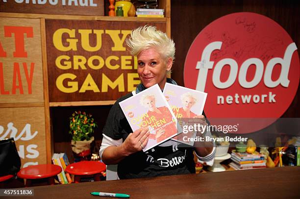 Chef Anne Burrell poses with her book "Own Your Own Kitchen" at the Grand Tasting presented by ShopRite featuring KitchenAid® culinary demonstrations...