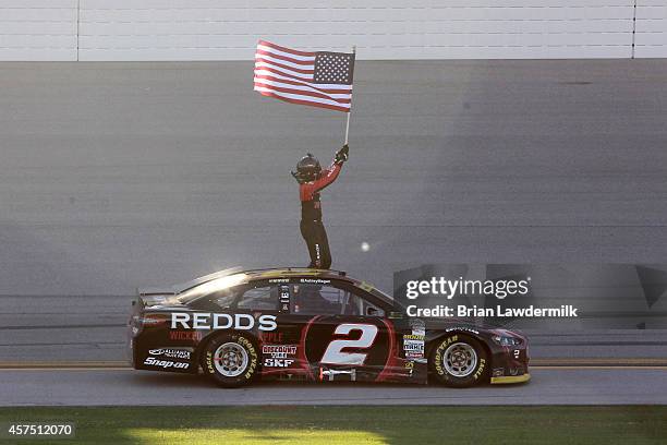 Brad Keselowski, driver of the Redd's Wicked Apple Ale Ford, celebrates after winning the NASCAR Sprint Cup Series GEICO 500 at Talladega...