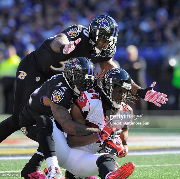 Baltimore Ravens' Dominique Franks and Albert McClellan bring down Atlanta Falcons' Roddy White after a fourth quarter catch on Sunday, Oct. 19 at...