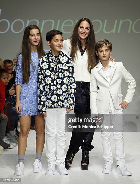 Designer Bonnie Young poses with Celia Babini, Kyah Cahill and Brando Babini on the runway during the Bonnie Young preview at petitePARADE / Kids...