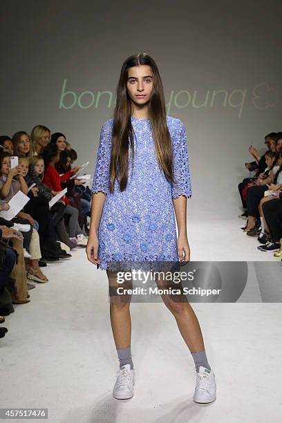Celia Babini walks the runway during the Bonnie Young preview at petitePARADE / Kids Fashion Week at Bathhouse Studios on October 19, 2014 in New...