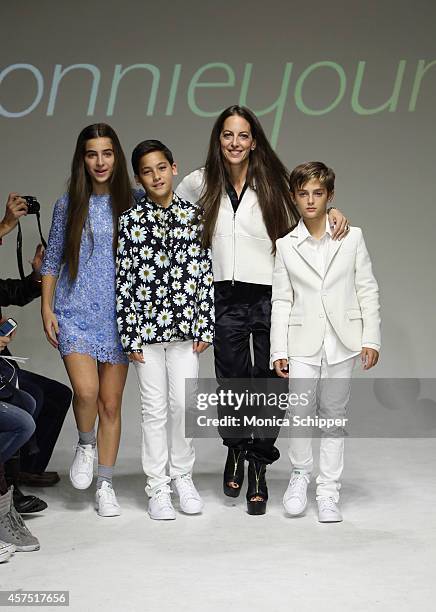 Designer Bonnie Young poses with Celia Babini, Kyah Cahill and Brando Babini on the runway during the Bonnie Young preview at petitePARADE / Kids...