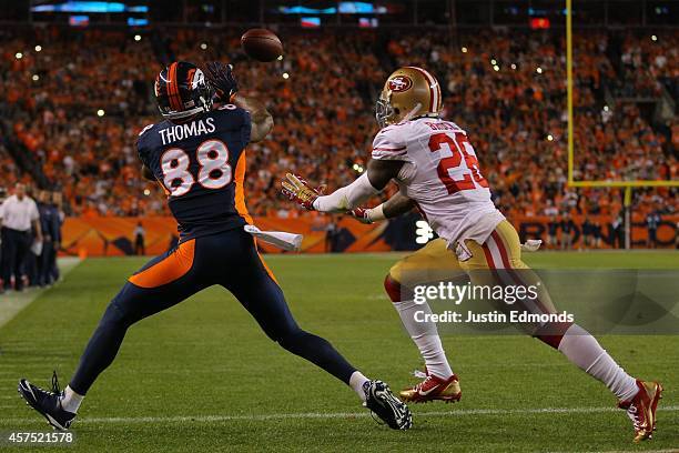 Wide receiver Demaryius Thomas of the Denver Broncos catches a touchdown pass from Peyton Manning under coverage by cornerback Tramaine Brock of the...