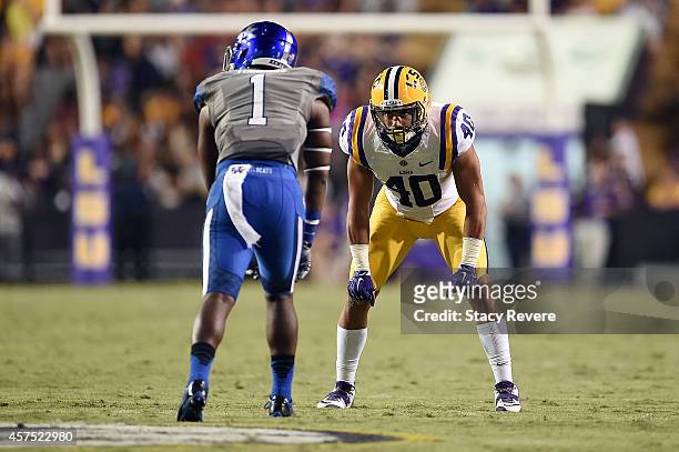 Duke Riley of the LSU Tigers works against Ryan Timmons of the Kentucky Wildcats during a game at Tiger Stadium on October 18, 2014 in Baton Rouge,...