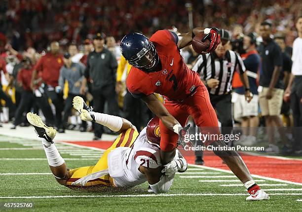 Wide receiver Cayleb Jones of the Arizona Wildcats runs with the football past safety Su'a Cravens of the USC Trojans during the college football...