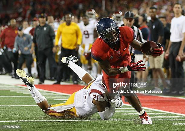 Wide receiver Cayleb Jones of the Arizona Wildcats runs with the football past safety Su'a Cravens of the USC Trojans during the college football...