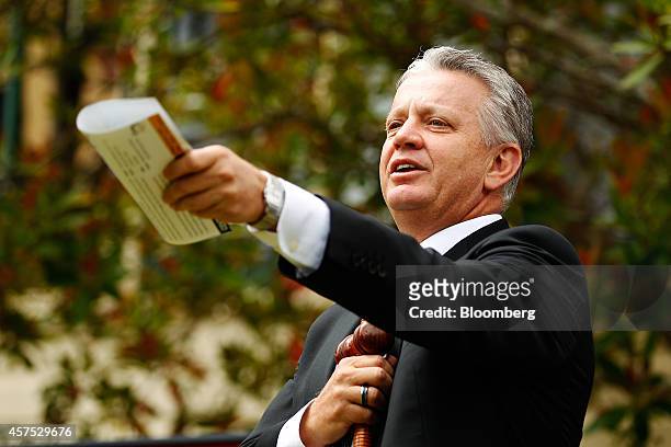 Auctioneer Craig Marshall gestures while conducting bidding during an auction of a property in the suburb of Roseville, Sydney, Australia, on...