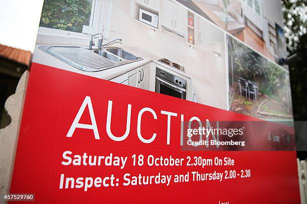 An auction sign stands on display outside a house in the suburb of Waverton in Sydney, Australia, on Saturday, Oct. 18, 2014. Sydneys median home...