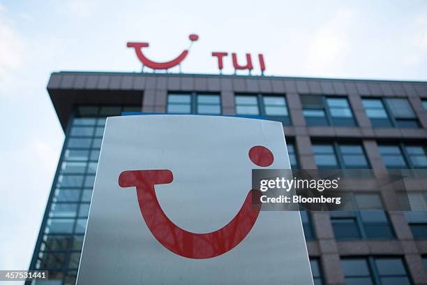 The TUI logo sits on a sign outside TUI AG's headquarters in Hamburg, Germany, on Wednesday, Dec. 18, 2013. TUI AG, Europe's largest tour operator,...