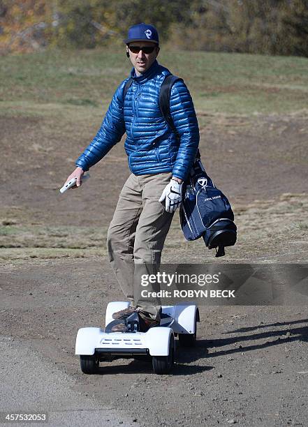 Paul Hodge, president and co-foundre of GolfBoard, rides a GolfBoard during a golf tournament at the Malibu Golf Club in Malibu, California December...